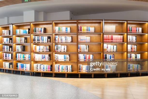 wooden three-dimensional bookcases in the library - resource library stock pictures, royalty-free photos & images