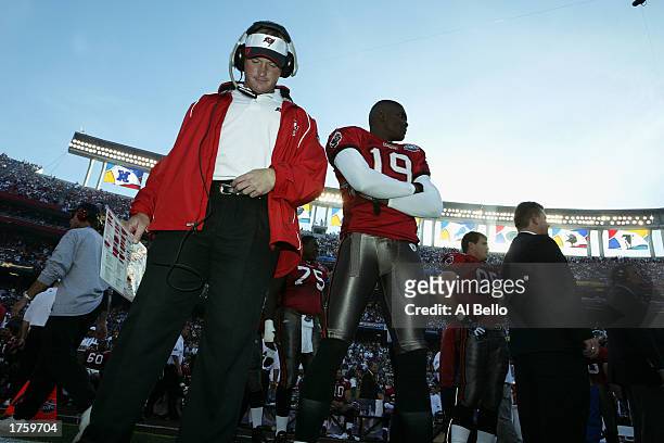 Head coach Jon Gruden and wide receiver Keyshawn Johnson of the Tampa Bay Buccaneers stand on the field before the start of Super Bowl XXXVII against...