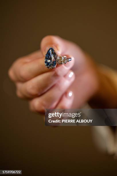 This photograph taken on November 2, 2023 in Geneva, shows "Bleu Royal", a rare 17,61 carats internally flawless fancy vivid blue pear shaped...