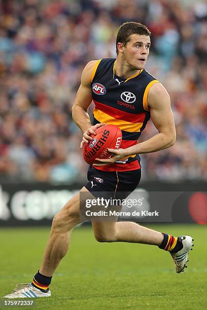 Brad Crouch of The Crows runs with the ball during the round 20 AFL match between the Adelaide Crows and the North Melbourne Kangaroos at AAMI...