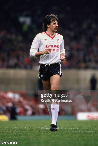 Liverpool defender Mark Lawrenson in action in the white adidas away kit during a First Division match against Manchester United at Old Trafford on...