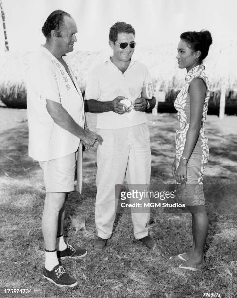 An interpreter translates for drama coach Harold Goodwin and French Polynesian actress Tarita Teriipia during location filming in the South Pacific...