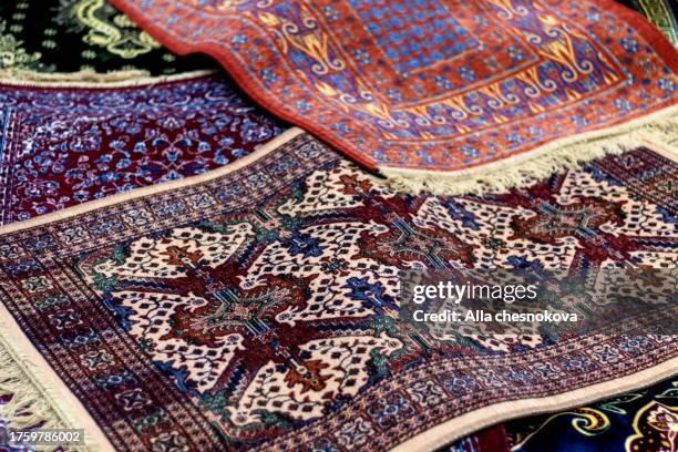 Lots of rugs with oriental patterns. Background, cover