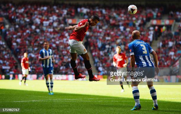 Robin van Persie of Manchester United heads in the opening goal during the FA Community Shield match between Manchester United and Wigan Athletic at...