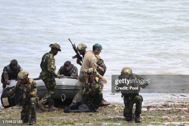 Soldiers perform a military exercise as King Charles III as Captain General of the Royal Marines visits the Mtongwe Naval Base on November 2, 2023 in...