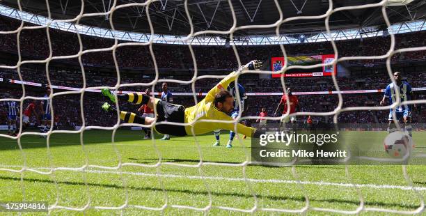 Goalkeeper Scott Carson of Wigan Athletic fails to stop the shot from Robin van Persie of Manchester United during the FA Community Shield match...