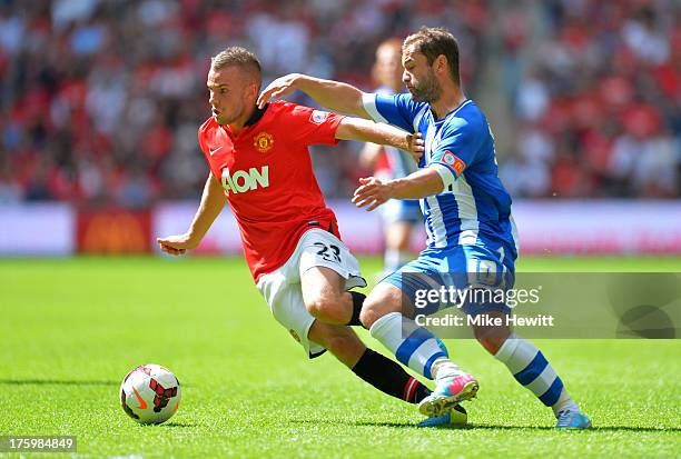 Tom Cleverley of Manchester United battles for the ball with Shaun Maloney of Wigan Athletic during the FA Community Shield match between Manchester...