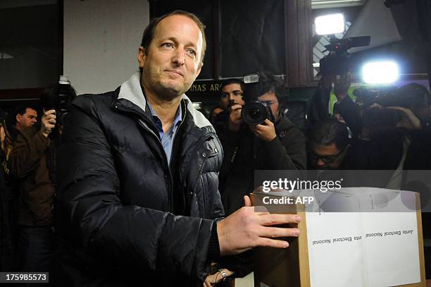 The mayor of Buenos Aires' Lomas de Zamora district and deputy candidate for the ruling Victory Front party, Martin Insaurralde, casts his vote...