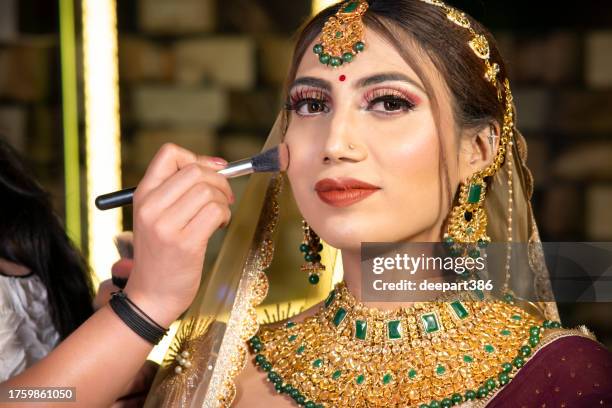 portrait of beautiful indian bride getting ready for her wedding ceremony. - indian bridal makeup stock pictures, royalty-free photos & images