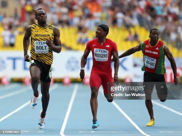 Usain Bolt of Jamaica, Mike Rodgers of the United States and Usain Bolt of Jamaica, Antoine Adams of Saint Kitts and Nevis compete in the Men's 100...