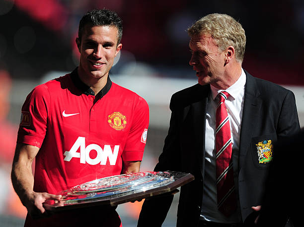 Robin van Persie of Manchester United and manager David Moyes with the trophy after victory in the FA Community Shield match between Manchester...