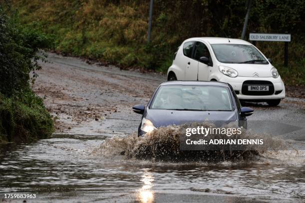 Car drives along a flooded road in Romsey, southern England, on November 2, 2023 as strong winds and heavy rain from Storm Ciaran hit Britain. High...