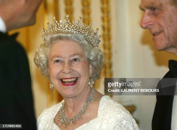 Queen Elizabeth II smiles prior to a dinner at the Elysee Palace in Paris Monday, April 5 2004, as the Queen starts a three-day state visit to France...