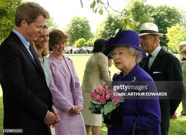 Earl Spencer greets Queen Elizabeth ll and the Duke of Edinburgh after the unveiling ceremony for the Princess Diana memorial fountain in London's...