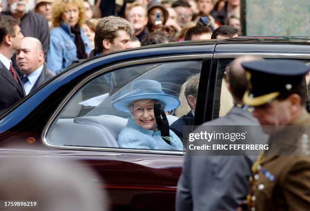 Queen Elizabeth II waves as she and Paris Mayor Bertrand Delanoe leave after a walkabout on the pedestrian Rue Montorgueil in Paris 06 April 2004, on...