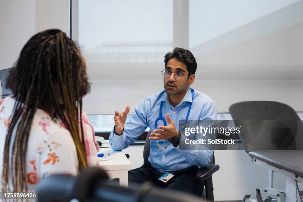 going over treatment options - general practitioner stock pictures, royalty-free photos & images