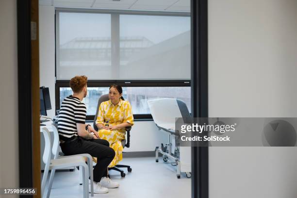 visiting my gp - medical examination room stock pictures, royalty-free photos & images
