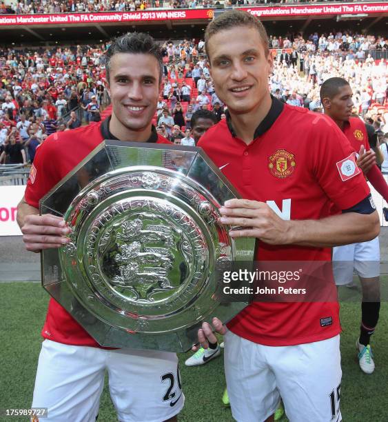 Robin van Persie and Nemanja Vidic of Manchester United pose with the FA Community Shield trophy after the FA Community Shield match between...