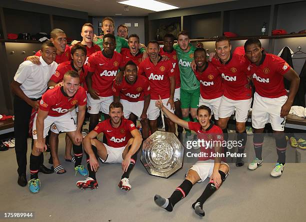 The Manchester United squad celebrate with the FA Community Shield trophy in the dressing room after the FA Community Shield match between Manchester...