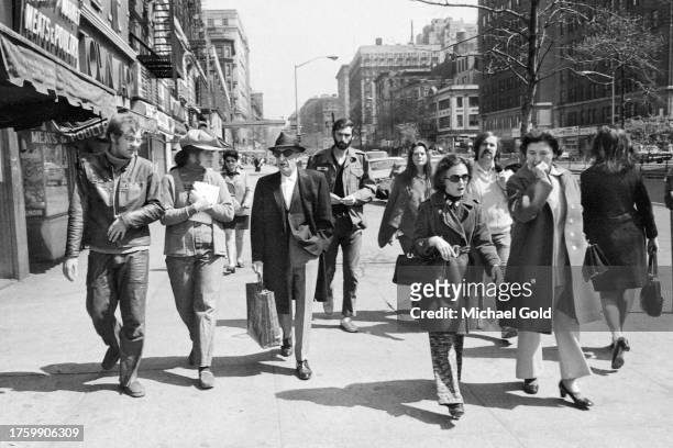 Group of eight, diverse people walking on Broadway on the Upper West Side of New York City, 1971.
