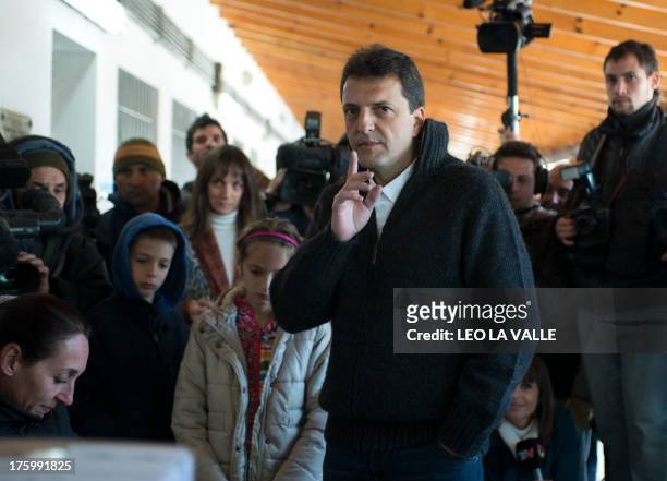 The mayor of the city of Tigre and deputy candidate of the Frente Renovador party, Sergio Massa, gestures before casting his vote during Argentina's...