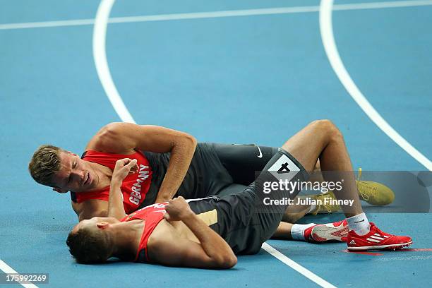 Pascal Behrenbruch of Germany and Michael Schrader of Germany Liechtenstein on the track afte rcompeting in the Men's Decathlon 1500 metres during...