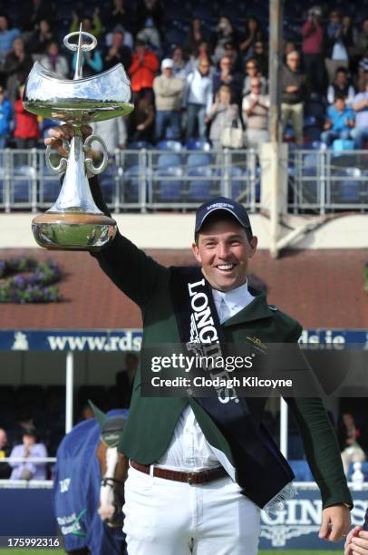 Cian O'Connor of Ireland celebrates with the trophy after winning on Blue Loyd 12 the Longines International Showjumping Grand Prix of Ireland with a...