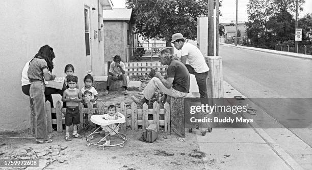 Large Hispanic family spends a Saturday afternoon at home in their front yard in Martineztown, an ethnic and historic section of Albuquerque, New...