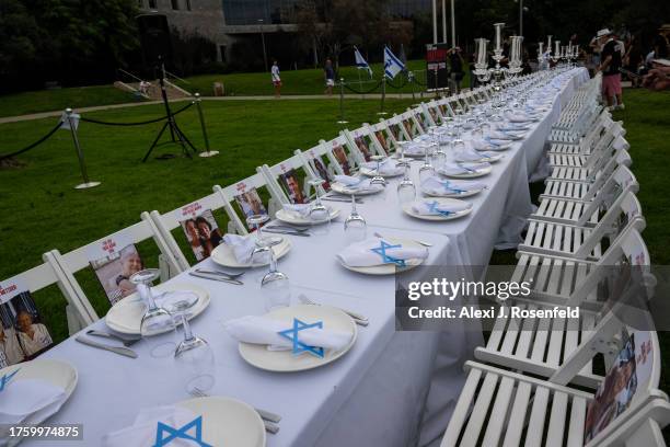 Shabbat Dinner" with table 229 empty seats, representing the hostages, is set up ahead of a special ‘Kabalat Shabbat,’ prayer service for the...