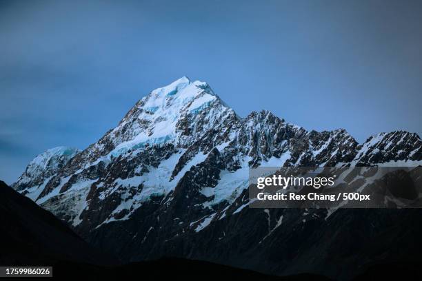 scenic view of snowcapped mountains against sky - 山 stock-fotos und bilder