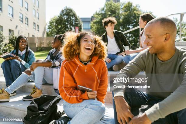 university students hanging out in campus - talking friends backlight stock pictures, royalty-free photos & images