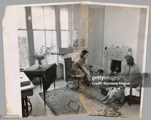 Composite image of a woman and three children in a living room, 1952. The 'join-up' consists of separate photographic prints, cut and joined...