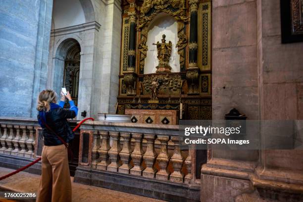 Person is seen taking pictures of one of the monuments in the church of Sao Vicente de Fora, located in the Graca neighborhood. Graca is a district...