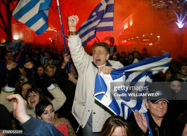Greek supporters celebrate the winning goal as a crowd of 30,000 gather at Melbourne's inner city to watch the final of Euro 2004 between Greece and...