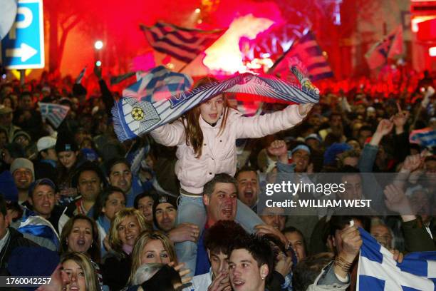 Greek supporters celebrate the winning goal as a crowd of 30,000 people gather at Melbourne's inner city to watch the final of Euro 2004 between...