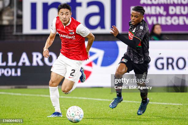 Yukinari Sugawara of AZ, Sontje Hansen of NEC run after the ball during the Dutch Eredivisie match between AZ and NEC at AFAS Stadion on October 29,...