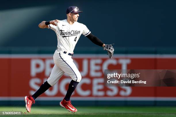 Carlos Correa of the Minnesota Twins throws the ball to first base to get out Jonah Heim of the Texas Rangers in the 13th inning at Target Field on...