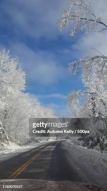 empty road amidst snow covered trees against sky,carlton,minnesota,united states,usa - carlton stock pictures, royalty-free photos & images