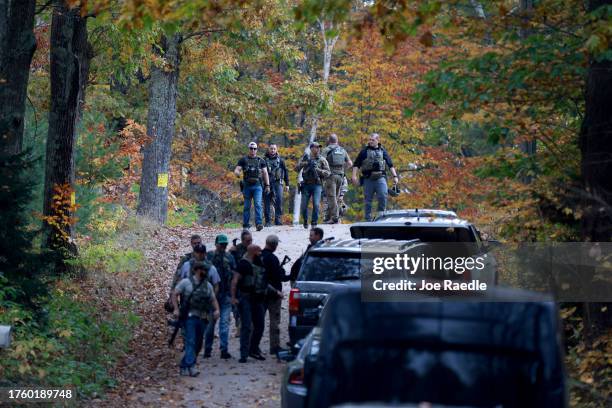 Law enforcement officials conduct a manhunt for suspect Robert Card following a mass shooting on October 27, 2023 in Lisbon, Maine. Police are...