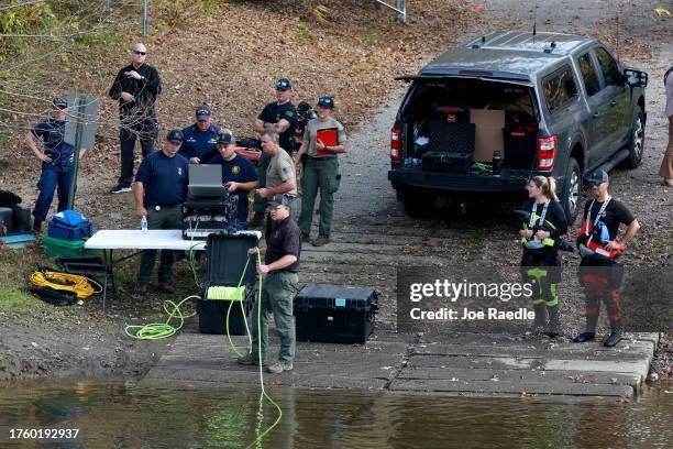 Law enforcement officers use an underwater robotic camera to search the water around the Pejepscot Boat Ramp on the Androscoggin River where the...