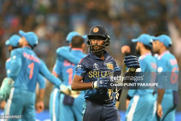 Sri Lanka's Charith Asalanka walks back to the pavilion after his dismissal during the 2023 ICC Men's Cricket World Cup one-day international match...