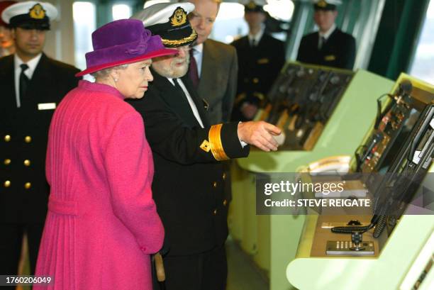 British Queen Elizabeth tours the bridge with Commodore Ron Warwick during the christening cermonies of the world's biggest ocean liner in...