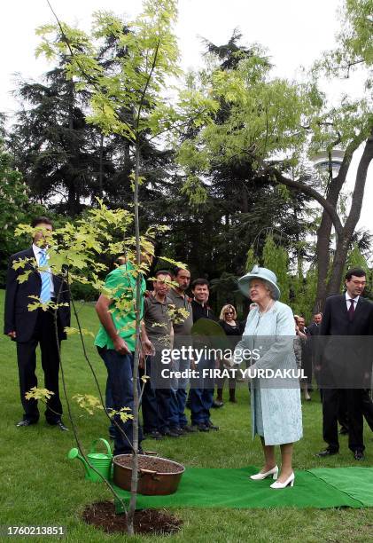 Britain's Queen Elizabeth II plants a tree during a ceremony at the British Embassy in Ankara on May 16, 2008. Queen Elizabeth II wrapped up a...