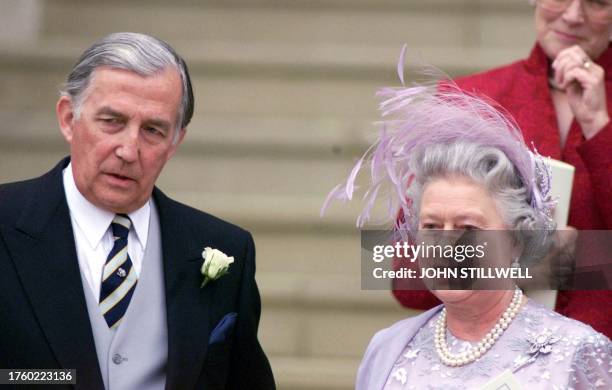 The Queen and Mr. Christopher Rhys-Jones, watch as their son and daughter leave in an open topped carrage, after their wedding from St. George's...