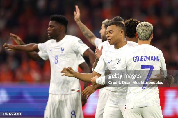 Kylian Mbappe of France celebrates with teammates after scoring the team's first goal during the UEFA EURO 2024 European qualifier match between...