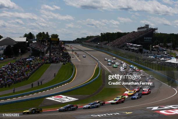 Marcos Ambrose, driver of the Stanley/CTC Jumpstart Ford, leads the field during the NASCAR Sprint Cup Series Cheez-It 355 at The Glen at Watkins...