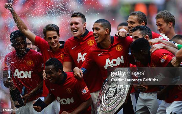 Phil Jones and Chris Smalling of Manchester United lead the celebrations with team mates after victory in the FA Community Shield match between...