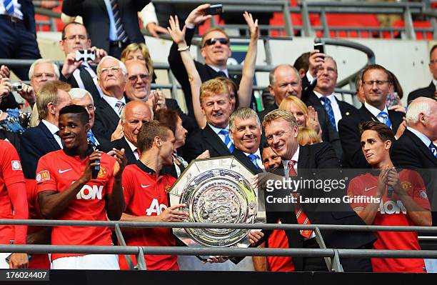 Nemanja Vidic of Manchester United and manager David Moyes with the trophy after victory in the the FA Community Shield match between Manchester...