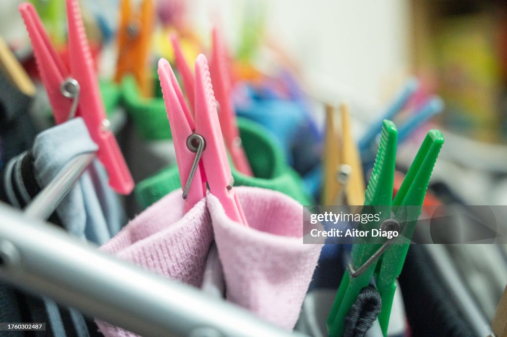 Close-up of socks hung up with drying clips.