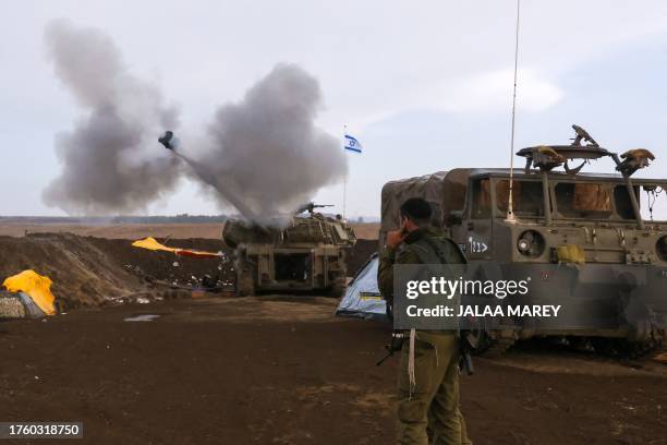 Soldier protects his ears as an Israeli artillery unit fires during a military drill in the annexed Golan Heights near the border with Lebanon on...